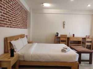 A bed or beds in a room at Sayami Home