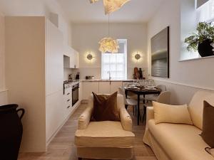a living room and kitchen with a couch and a table at Central Todmorden 2 Bedroom Apartment in Todmorden