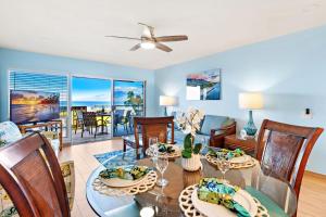 een eetkamer en woonkamer met een tafel en stoelen bij Oceanfront & Sunsets! ks a5- Sullivan in Kahana