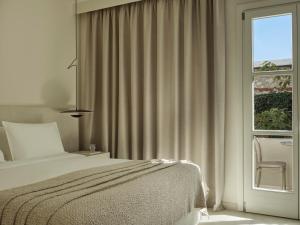 Postel nebo postele na pokoji v ubytování Doryssa Method Hotel