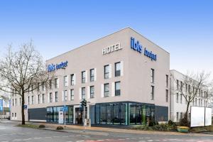 a large white building with a lot of windows at Ibis Budget Bamberg in Bamberg