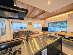 a kitchen with a sink and a counter top at Modern Beach House in Shimoda