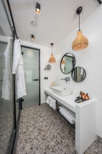 a bathroom with a sink and a mirror at Ölüdeniz Blu Luxury Unique Hotel - Adults-Only in Oludeniz