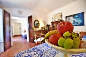 a bowl of fruit sitting on top of a table at Palazzo Alavolini - the loft suite in Fano