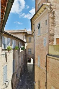 an alley way between two buildings with a tunnel at Palazzo Alavolini - the loft suite in Fano