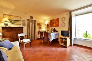 a living room with a table and a television at Palazzo Alavolini - the loft suite in Fano +30 photos