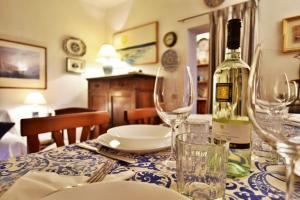 a table with a bottle of wine and glasses on it at Palazzo Alavolini - the loft suite in Fano