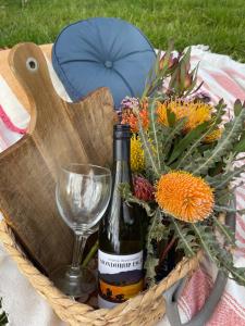 a basket with a bottle of wine and a glass at Mondurup Escape - Kendenup in Kendenup