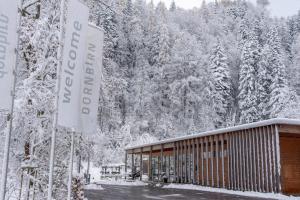 a sign in front of a building in the snow at Apartment am Camping Dornbirn - 211 Hangspitze in Dornbirn