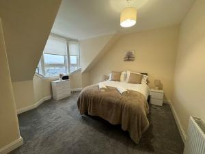 a bedroom with a bed and a large window at Myreslaw Green Apartment, Hawick Scottish Borders in Hawick