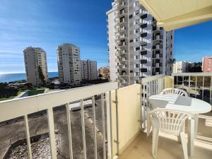 a balcony with a table and chairs and a view of the city at 4D Torre Rafael - Casas & Papéis in Armação de Pêra