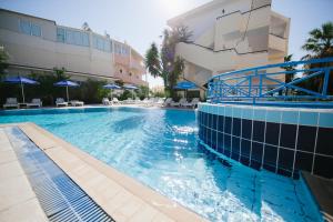 a swimming pool in front of a building at Artemis Comfort&Pleasure in Faliraki