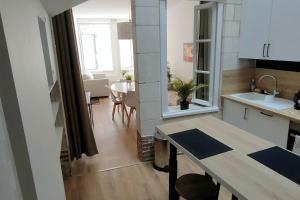 a small kitchen with a table and a dining room at Joli appartement avec cachet dans le Vieux Lille in Lille