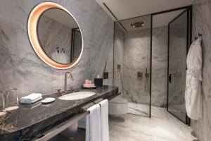a bathroom with a sink and a mirror at Glens Palas Istanbul Nisantasi in Istanbul +42 photos