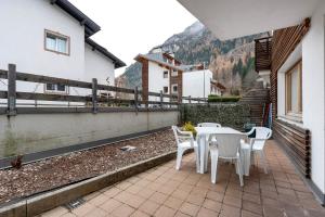 a patio with a table and chairs on a balcony at Night and day 3 in Predazzo