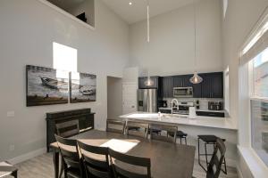 a kitchen and dining room with a table and chairs at Burl By The Bay in Ocean Shores
