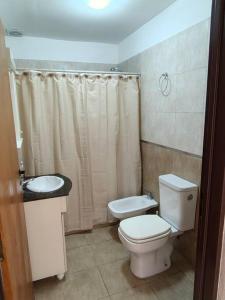 a bathroom with a toilet and a sink at Rooftop Velez Sarsfield in Buenos Aires
