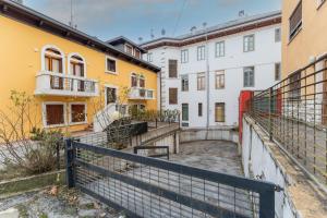 a row of buildings with yellow and white at Fuori da ZTL - Asiago a due passi da tutto in Asiago