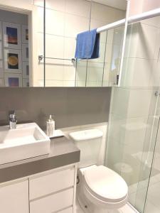 a white bathroom with a toilet and a sink at RCM Vilas - Porto Picarras in Piçarras +10 photos