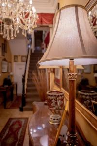 a lamp on a table in a room with a staircase at Hotel Rouge & Deco Suites in Blackpool