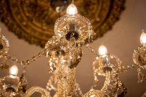 a gold chandelier in front of a mirror at Hotel Rouge & Deco Suites in Blackpool