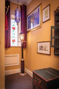 a lamp in a room with a table and a window at Hotel Rouge & Deco Suites in Blackpool