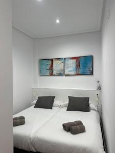 Un dormitorio con una cama con dos almohadas encima. en La Terraza, en Ávila