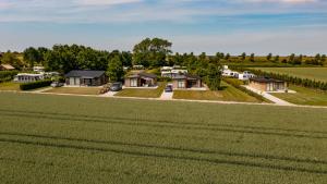 an aerial view of a large green field with houses at Landgoed Oud Bommenede in Zonnemaire
