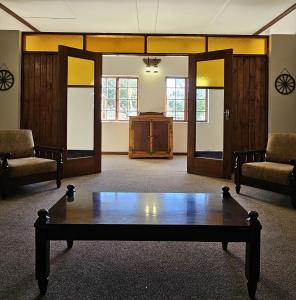 a room with a table in the middle of a room at Leeu Gamka Hotel in Leeu-Gamka