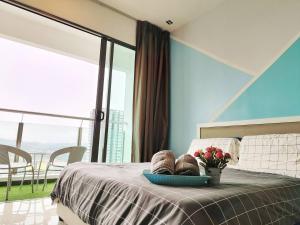 a bedroom with a bed with a bowl of flowers on it at 7INN Evo Soho Bangi (Free Parking, WIFI, Netflix) in Bandar Baru Bangi +24 photos