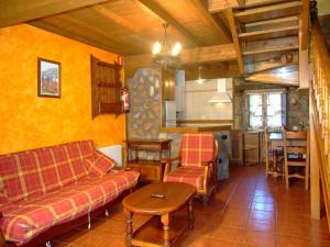 a living room with a couch and a table at Las Casucas de Ason in Arredondo