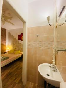 a bathroom with a sink and a bed in a room at Europe Station Rooms in Parma
