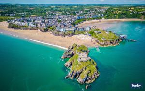 an aerial view of a small island in the ocean at Lower Deck in Tenby