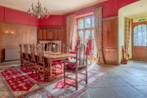 a dining room with a wooden table and chairs at Hockwold Hall - Former Royal residence in Hockwold cum Wilton