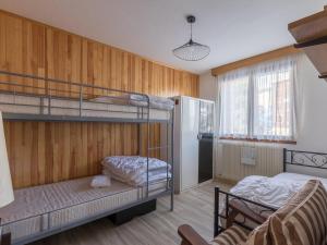 a room with two bunk beds and a couch at Les Marmottes 2 N 69 - 3P7 in Orcières