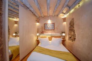 a small bedroom with two beds in a room at Alfama Charming and Rustic in Lisbon