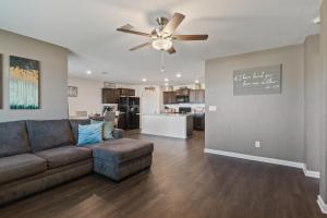 Una sala de estar con un sofá y un ventilador de techo. en New Bama Retreat Sleeps 8, en Tuscaloosa
