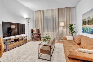 a living room with a couch and a flat screen tv at JAKSE-Apartments - Urban Jungle - top Lage & flexibler Checkin in Bochum