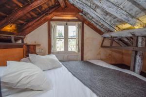 a bedroom with a large white bed with a window at Alfama Charming and Rustic in Lisbon +37 photos