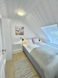 a bedroom with a bed with a roof at Hawbakkens 3 Skønne Ferieboliger in Hjørring
