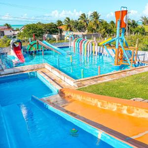 a large pool with a water park with slides at Pousada Bugaendrus in Touros +40 photos