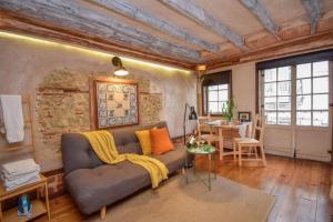 a living room with a couch and a table at Alfama Charming and Rustic in Lisbon