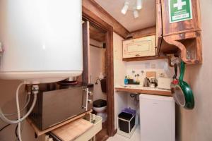 a small kitchen with a sink and a refrigerator at Alfama Charming and Rustic in Lisbon