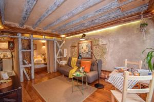 a living room with a couch and a table at Alfama Charming and Rustic in Lisbon