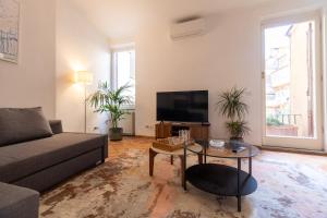 a living room with a couch and a tv at Terrazza Minerva in Rome