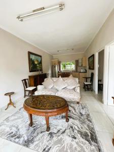 a living room with a couch and a coffee table at 3B Annie's Place Rawdons Country Estate in Nottingham Road