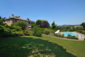 un gran patio con una casa y una piscina en Fonte Al Noce, en Gubbio