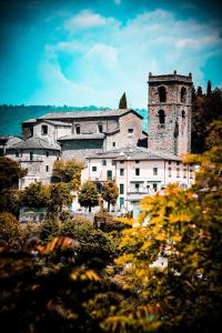 an old building with a tower and a church at Casa Natalina in Montecatini Terme