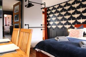 a bedroom with a bed with a flag on the wall at Stylish Escape With Wood-Fired Hot Tub in Norwich
