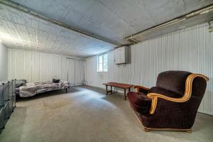 a room with a couch and a table and a bed at Le Ministère de la Paix - 15min to Gare du Nord in Soisy-sous-Montmorency